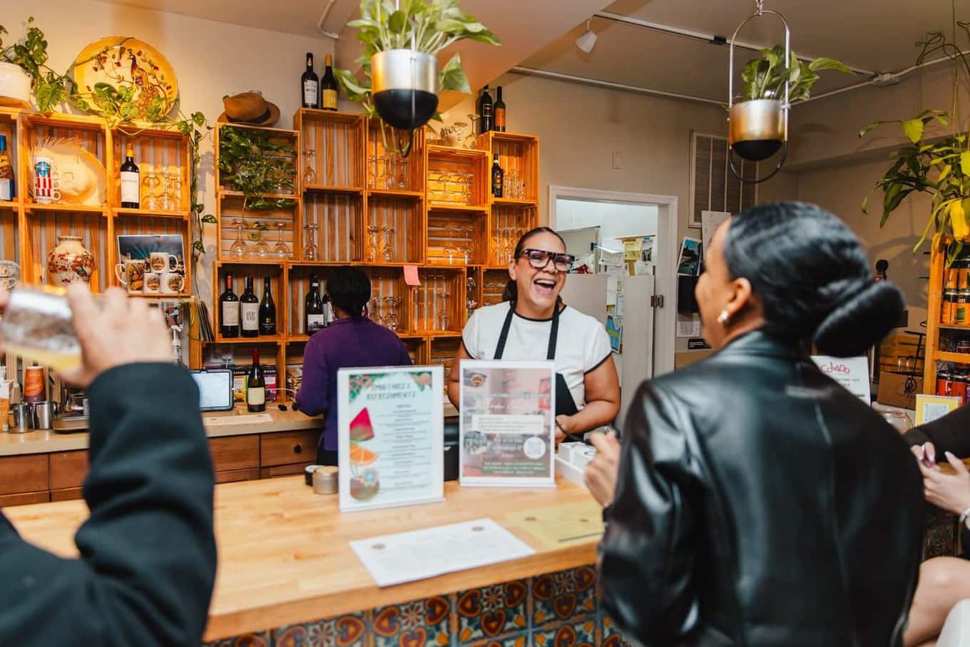 Colado Latino Network guests laughing together at Bodega and Vino